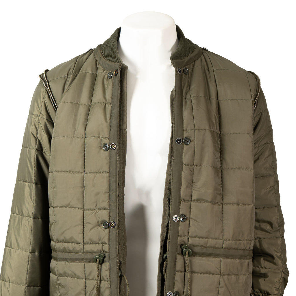 Interior view of the quilted liner, highlighting the button attachments for the parka.