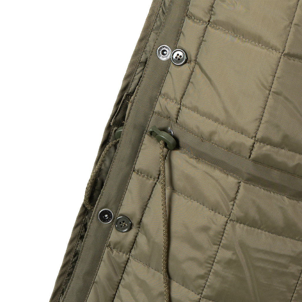 Close-up of the liner attachment toggles and drawstrings used to adjust the parka fit.