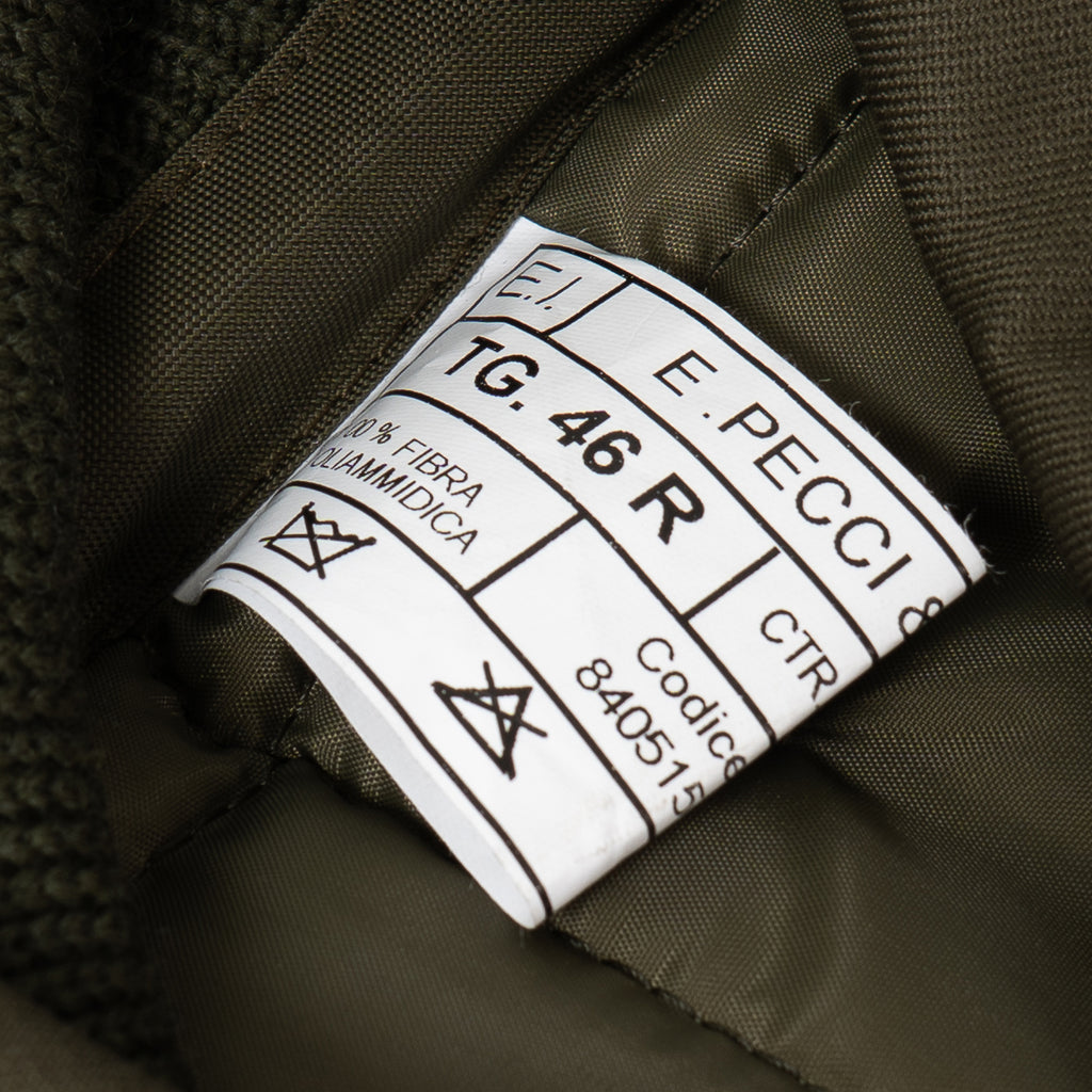 Close-up of the official military garment label with size and manufacturing details.