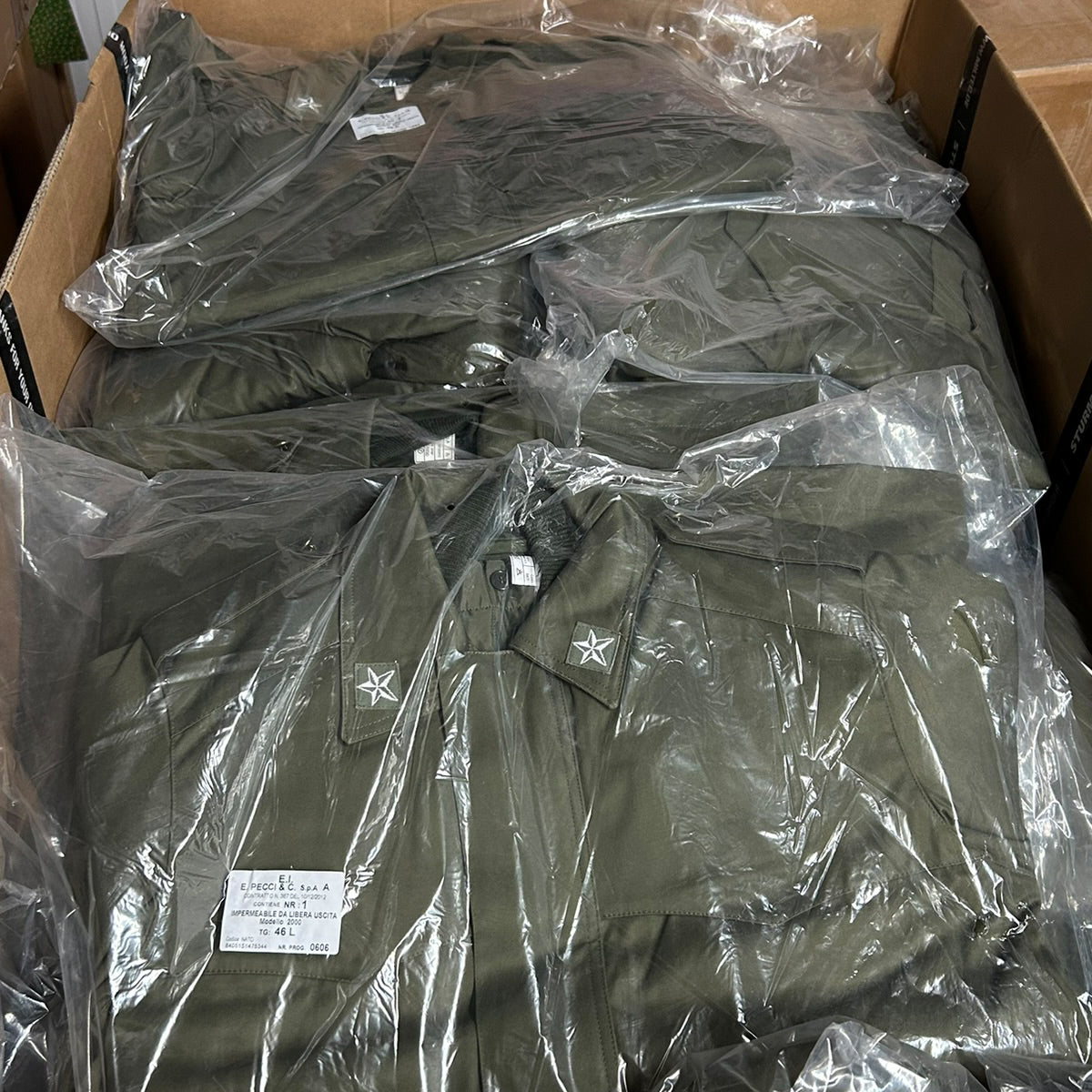 Multiple unissued Italian Army Roma 75 Parkas packed in their original plastic factory wrap.