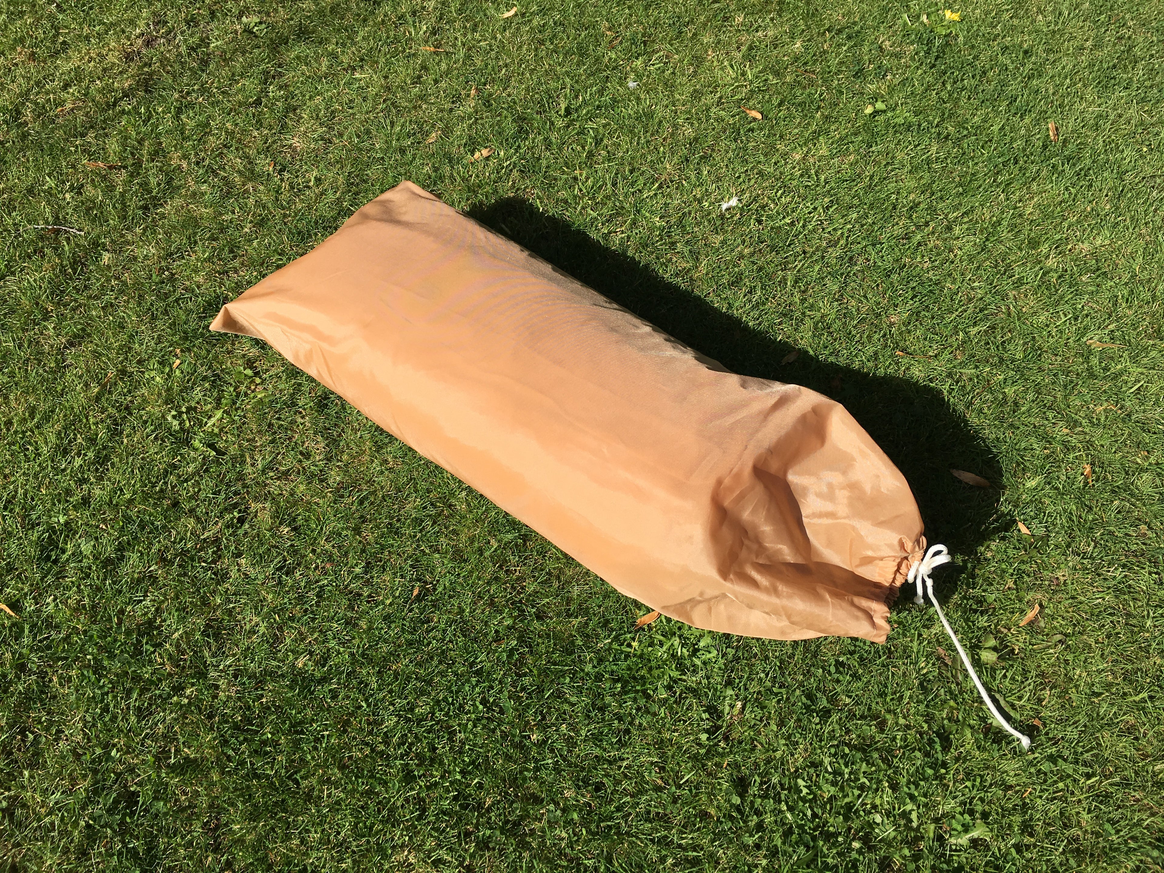 Packed French military two-man tent inside its bespoke nylon carry bag on the lawn.