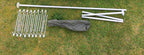 Bespoke nylon tent bag, modular poles, and steel pegs laid out on the grass.
