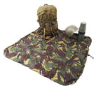 A full backpack, helmet, and flask placed on an unfolded Dutch Army woodland camouflage Bergen cover used as a ground sheet.