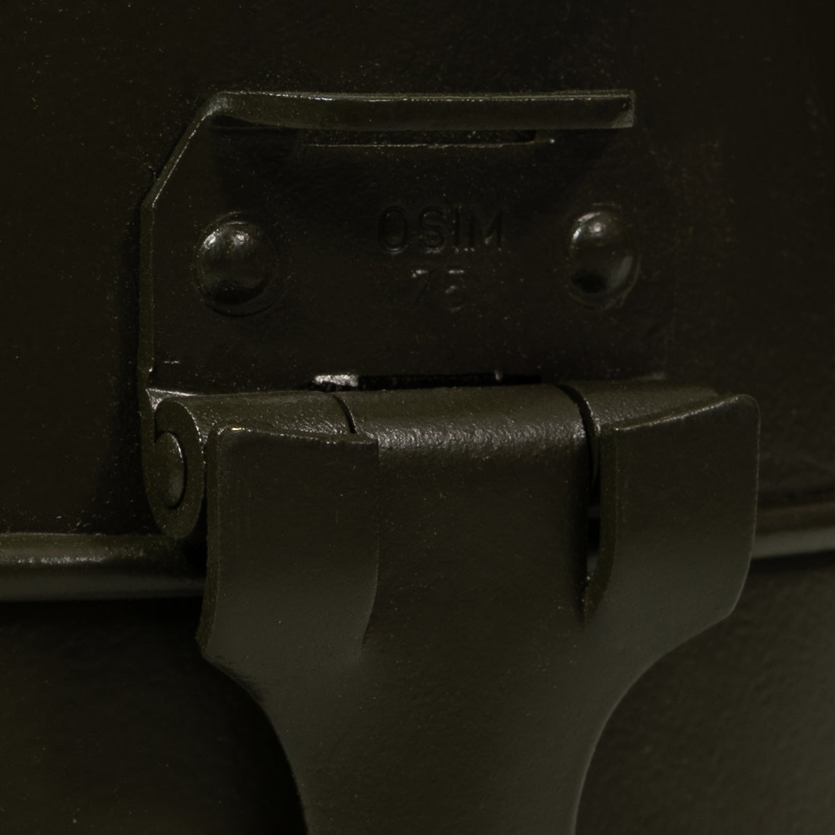 Close-up detail of the metal latch on an Italian Army mess tin clearly marked with OSIM 75, indicating Cold War era origin.