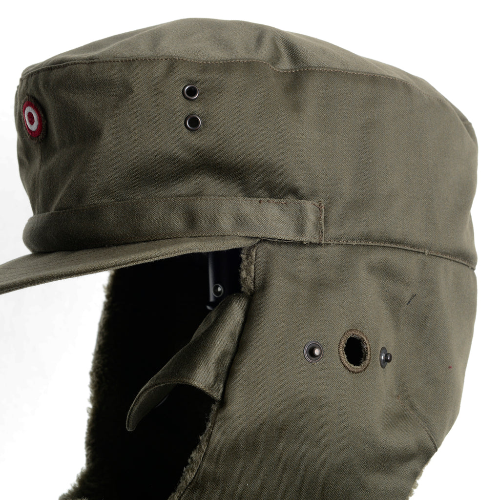 Close-up detail of the Austrian KAZ 75 winter cap, showcasing the button-covered side hearing port and robust military-grade stitching.