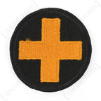 Original US 33rd Infantry Division embroidered patch front view showing yellow cross on black circular background