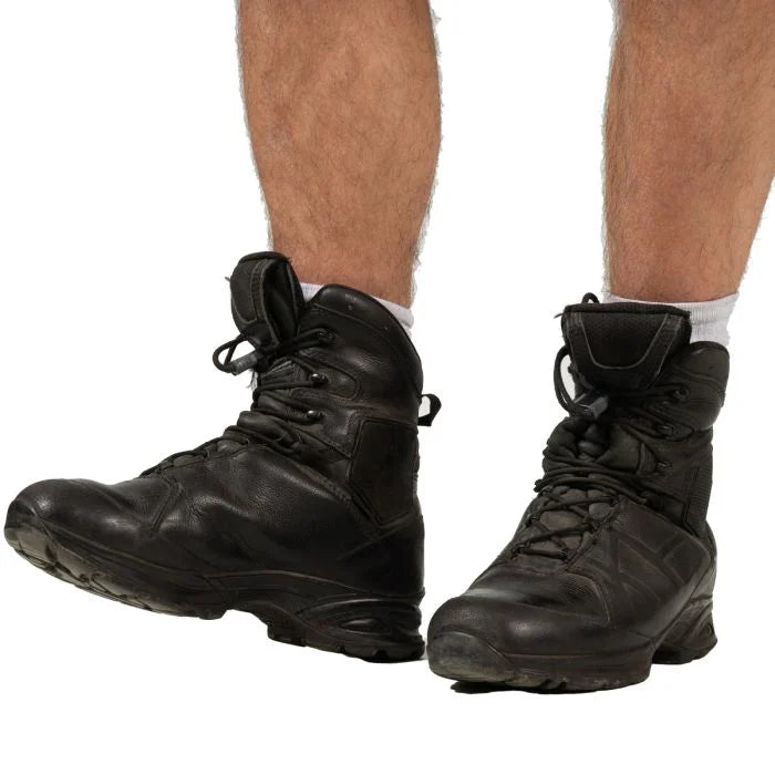Side view of black Meindl combat hiking boots being worn
