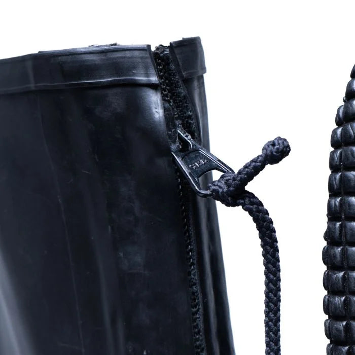 Detailed close-up of the durable YKK front metal zipper with a black braided cord pull tab on the German overshoe boot.
