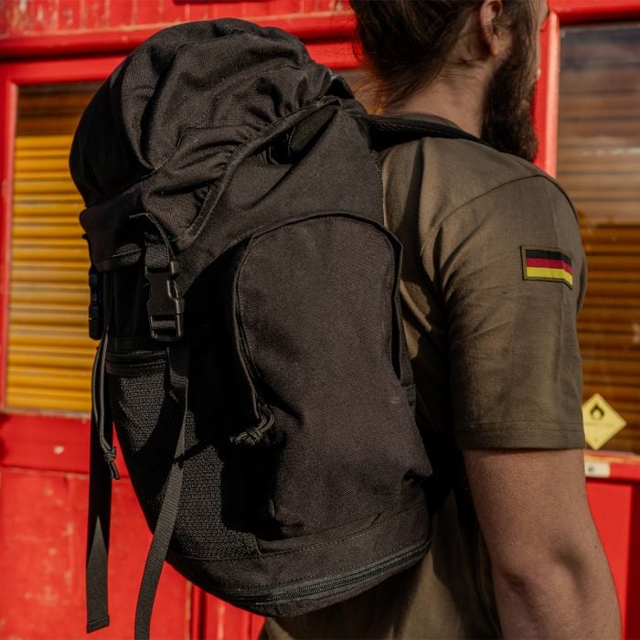 Side view of Original British Army Black Day Sack highlighting side zipped pouch
