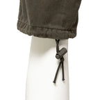 Close-up of the elasticated ankle drawstring and toggle adjuster on Austrian combat trousers.
