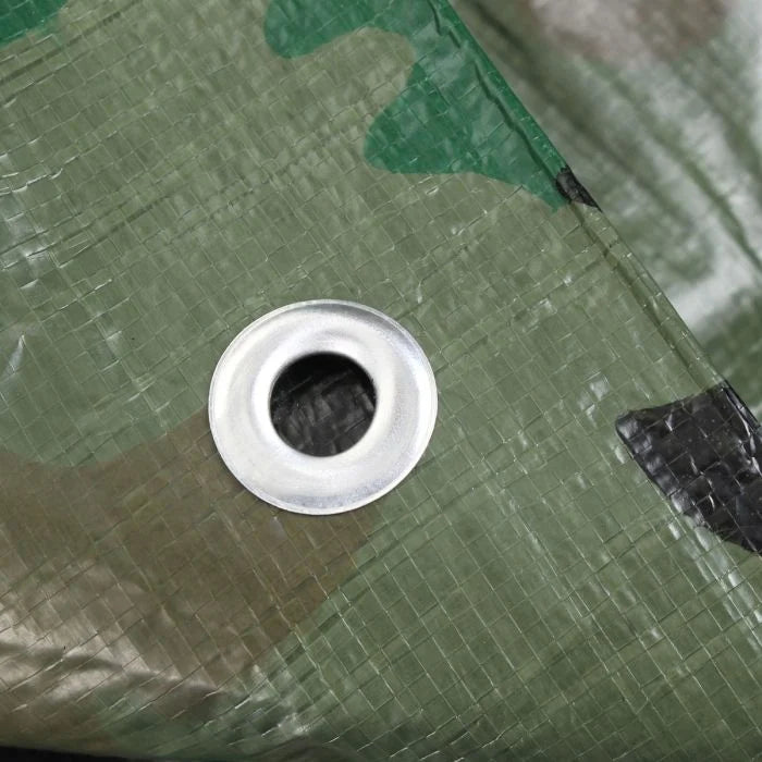 Detail view of silver metal eyelet grommet set into woven polyethylene camo tarp material
