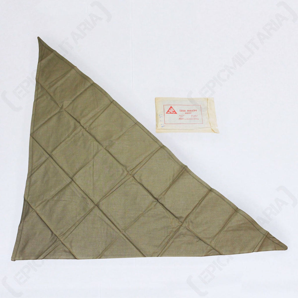 Full view of the unfolded olive drab cotton triangular scarf laid out alongside its original paper storage packet.