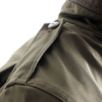 Close-up of the shoulder epaulette on the Austrian military field jacket featuring a sturdy button closure.