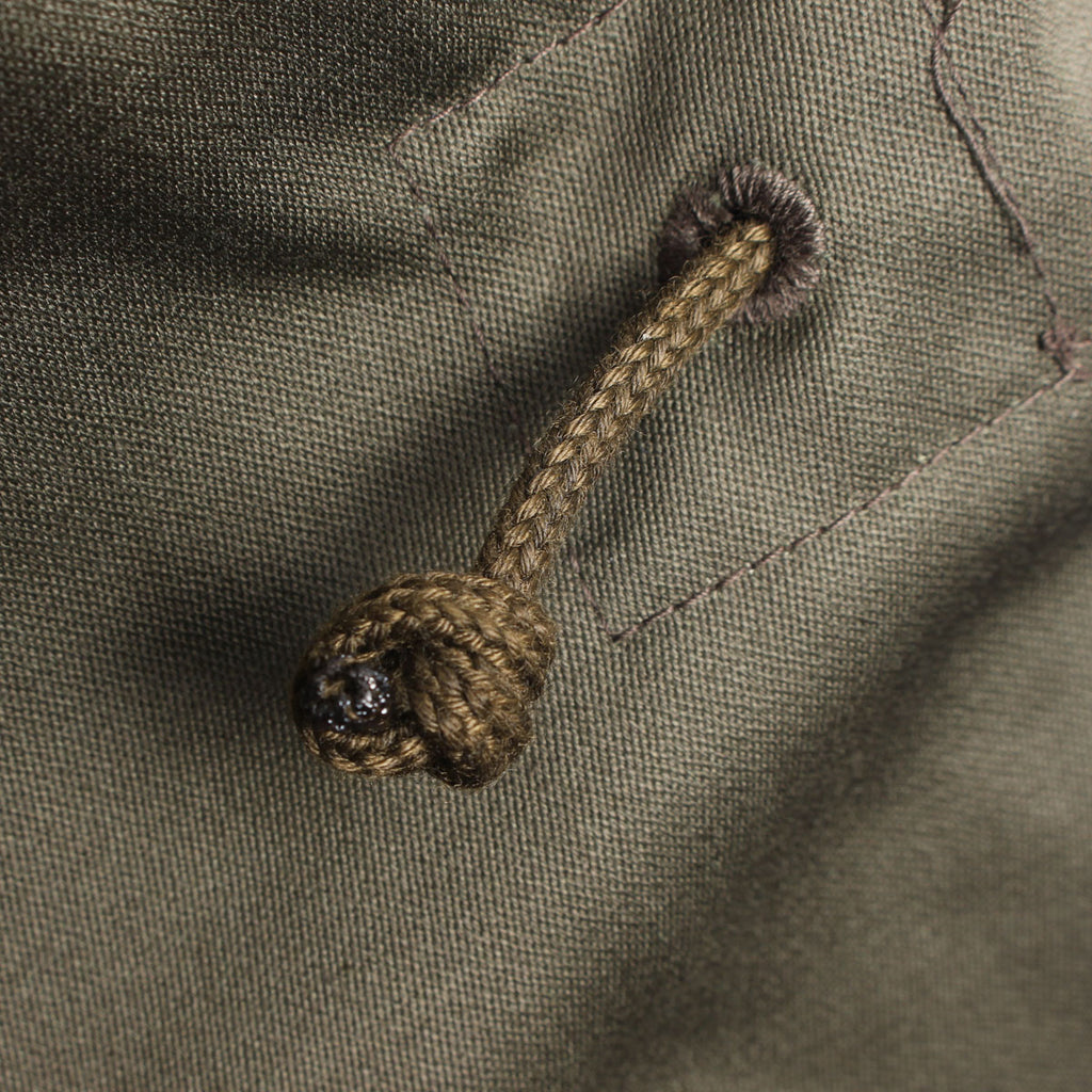 Detail of the durable fabric drawcord used for adjusting the waist of the field jacket.