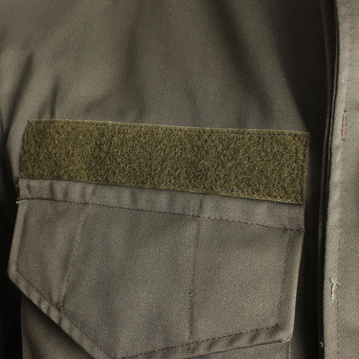 Close-up of the Velcro ID patch on the chest of the authentic Austrian olive drab field parka.