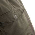 Side profile of the parka showing the heavy-duty metal zipper and protective storm flap construction.