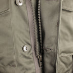 View of the heavy-duty front metal zipper protected by a wide storm flap to block cold drafts.