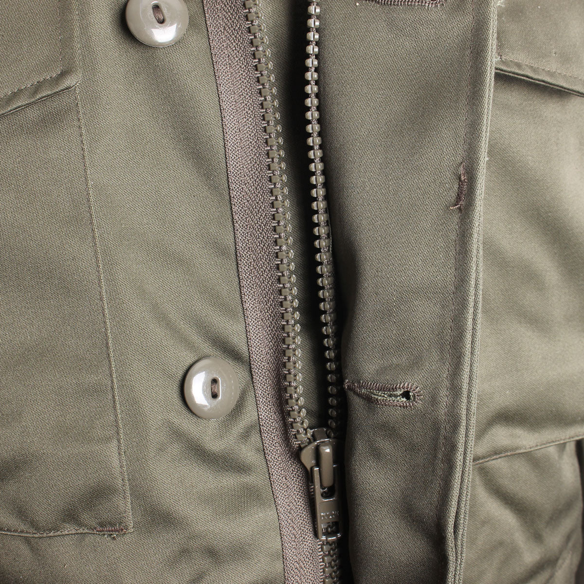 View of the heavy-duty front metal zipper protected by a wide storm flap to block cold drafts.