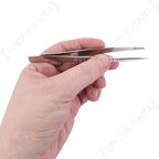 Polish Army stainless steel tweezers held in hand showing 130mm length scale