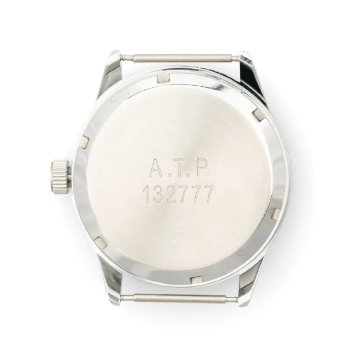 Close-up of the polished screw-down case back with stamped ATP and serial number markings