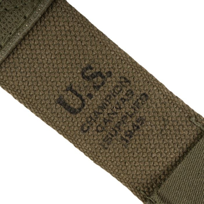 Close-up of the stenciled US stamp and Champion Canvas Supplies 1945 maker mark on the webbing.