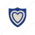 Front view of original US XXIV Corps embroidered shield patch featuring white heart on blue background