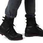 Austrian Army double buckle combat boots worn on feet with grey trousers, showing the high-ankle fit.