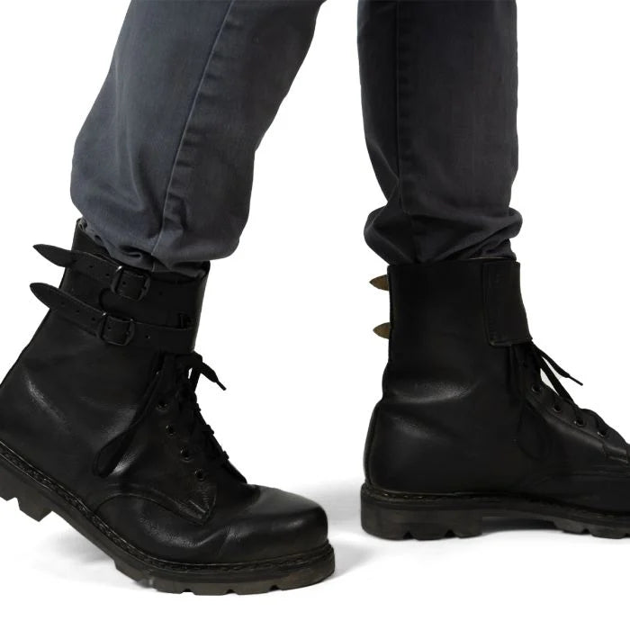 Austrian Army double buckle combat boots worn on feet with grey trousers, showing the high-ankle fit.