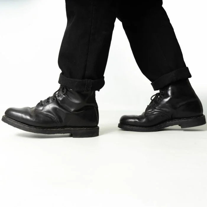 Side profile of worn Austrian Army double buckle combat boots during movement