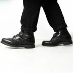 Side profile of worn Austrian Army double buckle combat boots during movement