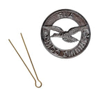 Back of the British Cadet beret badge with the brass cotter pin removed and shown alongside