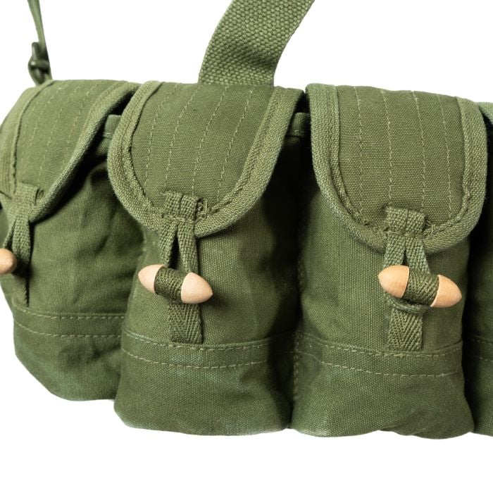 Close-up of the individual canvas pouches with wooden toggle fasteners on the SKS chest rig