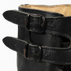 Close-up view of the double metal buckles and leather ankle straps on an Austrian M75 combat boot.