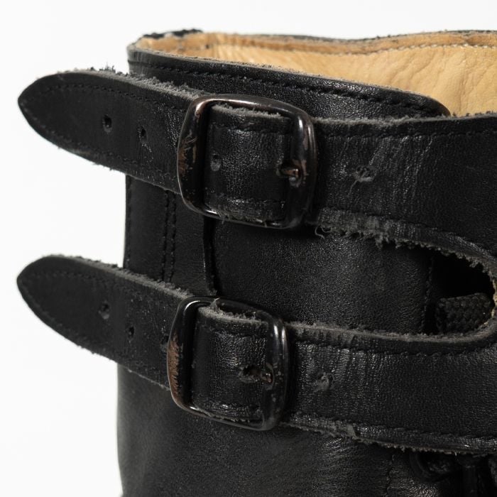 Close-up view of the double metal buckles and leather ankle straps on an Austrian M75 combat boot.