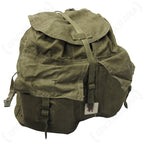 Front view of an olive green Czech M60 canvas backpack showing the teardrop shape, dual external storage pockets, and secure metal buckle strap closures.