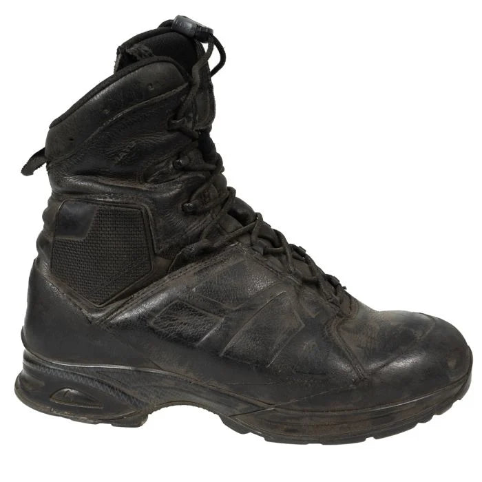 Lateral side view of the black leather Haix combat boot featuring the padded hexagonal ankle protection panel and high-ankle collar.