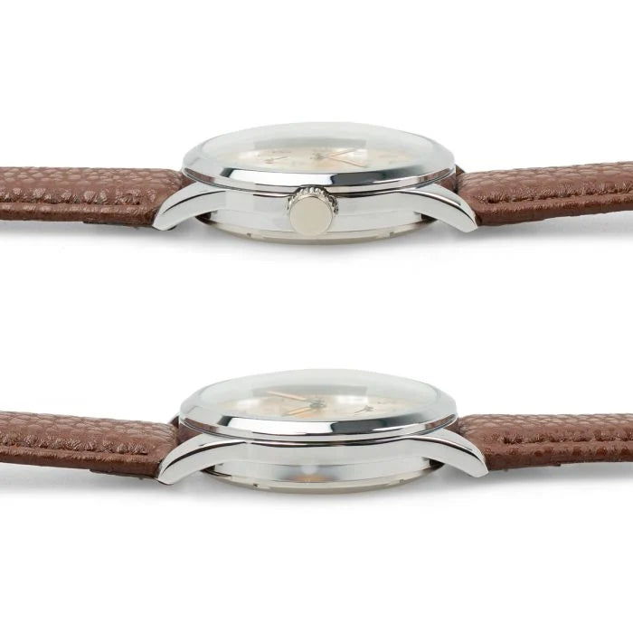 Side profile showing the domed crystal, slim polished case, and adjustment crown