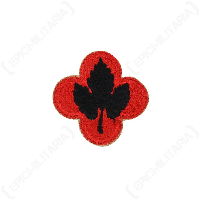 Front view of an original US 43rd Infantry Division shoulder patch featuring a black grape leaf on red background