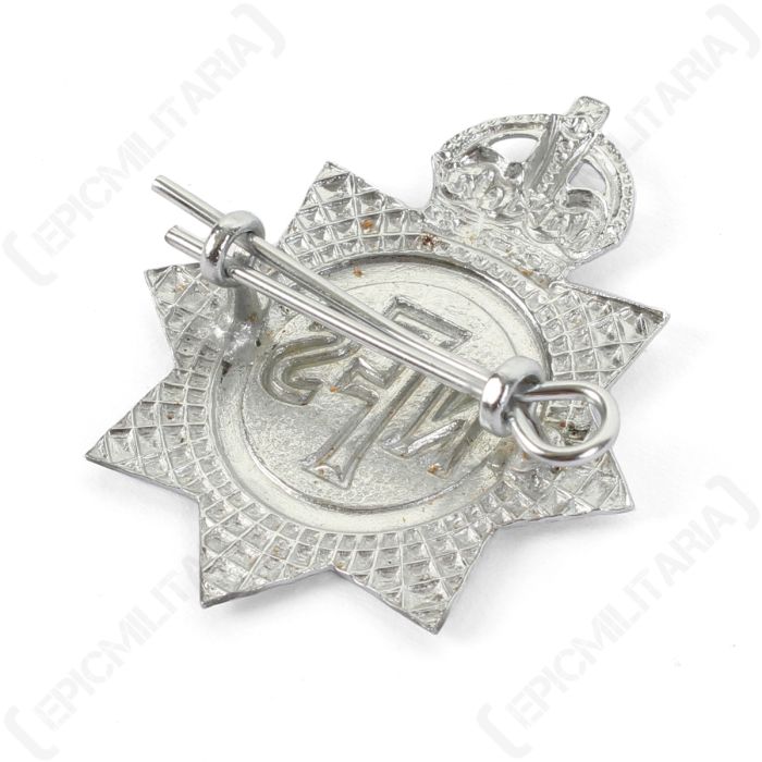 Angled rear view of WW2 British NFS cap badge highlighting die-cast metal detail and lug fastening