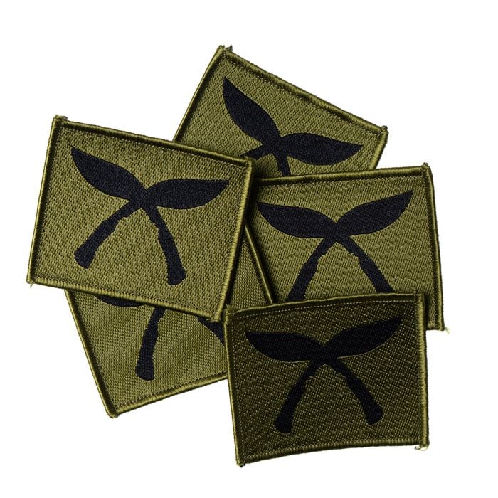 A pile of five unissued British Army Gurkha Brigade TRF patches in pristine supergrade surplus condition.