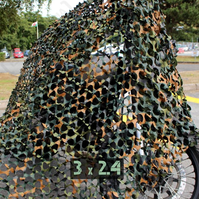 Flecktarn camouflage netting 2.4m x 3m draped over a vehicle for outdoor concealment