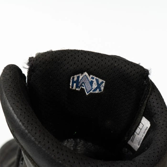 Close-up of the interior tongue label of the Haix combat boot showing the blue and white embroidered HAIX logo.