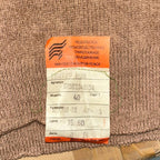 Original orange Cyrillic paper manufacturer tag from Podolsk Knitting Factory dated March 1991 on the Soviet jumper.