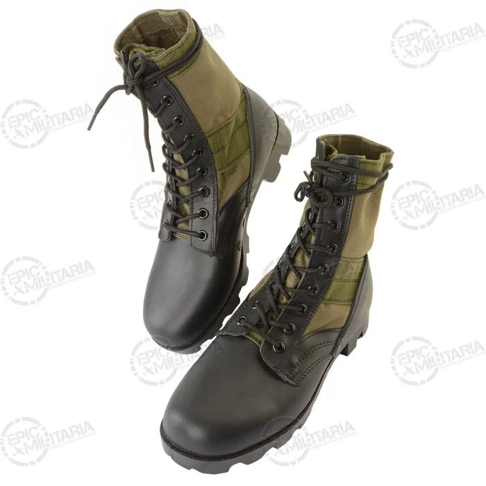 Top down angled view of olive drab canvas and black leather tropical combat boots