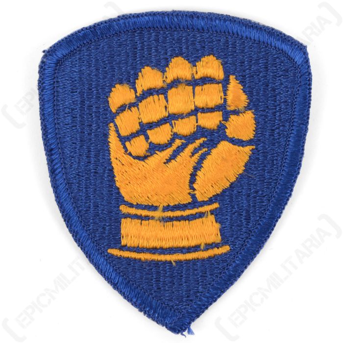 Front view of the original US 46th Infantry Division shoulder patch with gold clenched fist on blue background