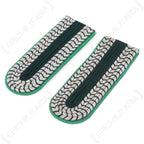 Angled view of vintage GDR police shoulder boards featuring distinctive Waffenfarbe light green piping and authentic police braid construction.