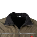 Close-up view of the stand-up collar and front zip pull on the Austrian Army Sportanzug 03 jacket.
