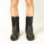 Front view of a pair of German Army rubber overboots being worn, highlighting the closed front zippers.