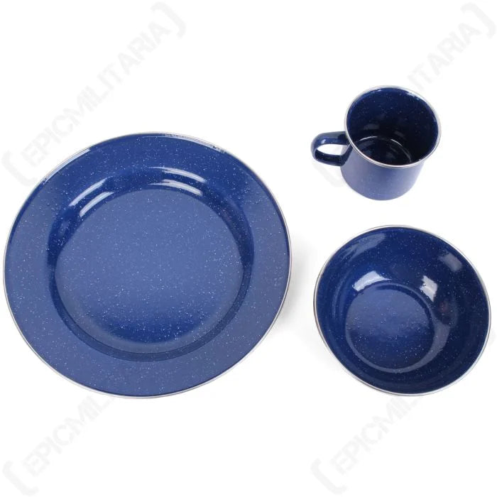 Top-down view of blue speckled enamel plate, bowl, and mug outdoor tableware set.