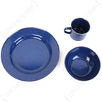 Top-down view of blue speckled enamel plate, bowl, and mug outdoor tableware set.